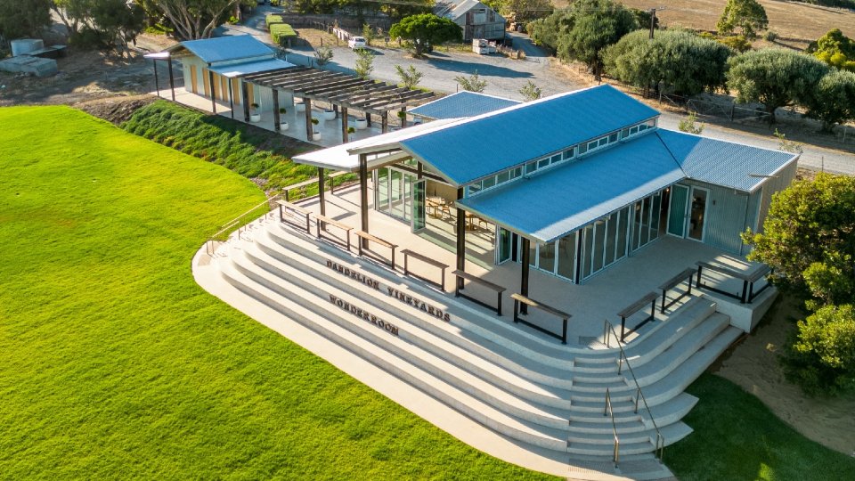 An aerial view of a modern building surrounded by curved steps.